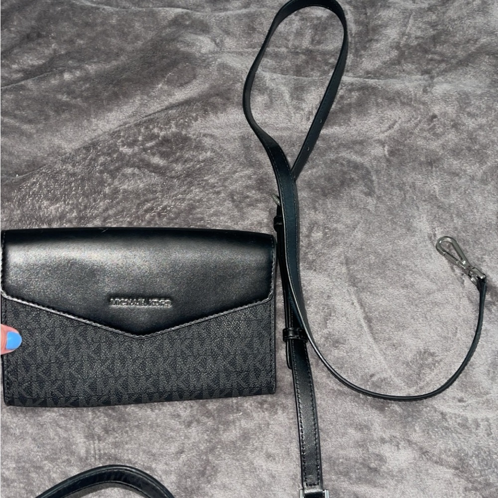 Used black Michael Kors bag comes with pouch and long strap.